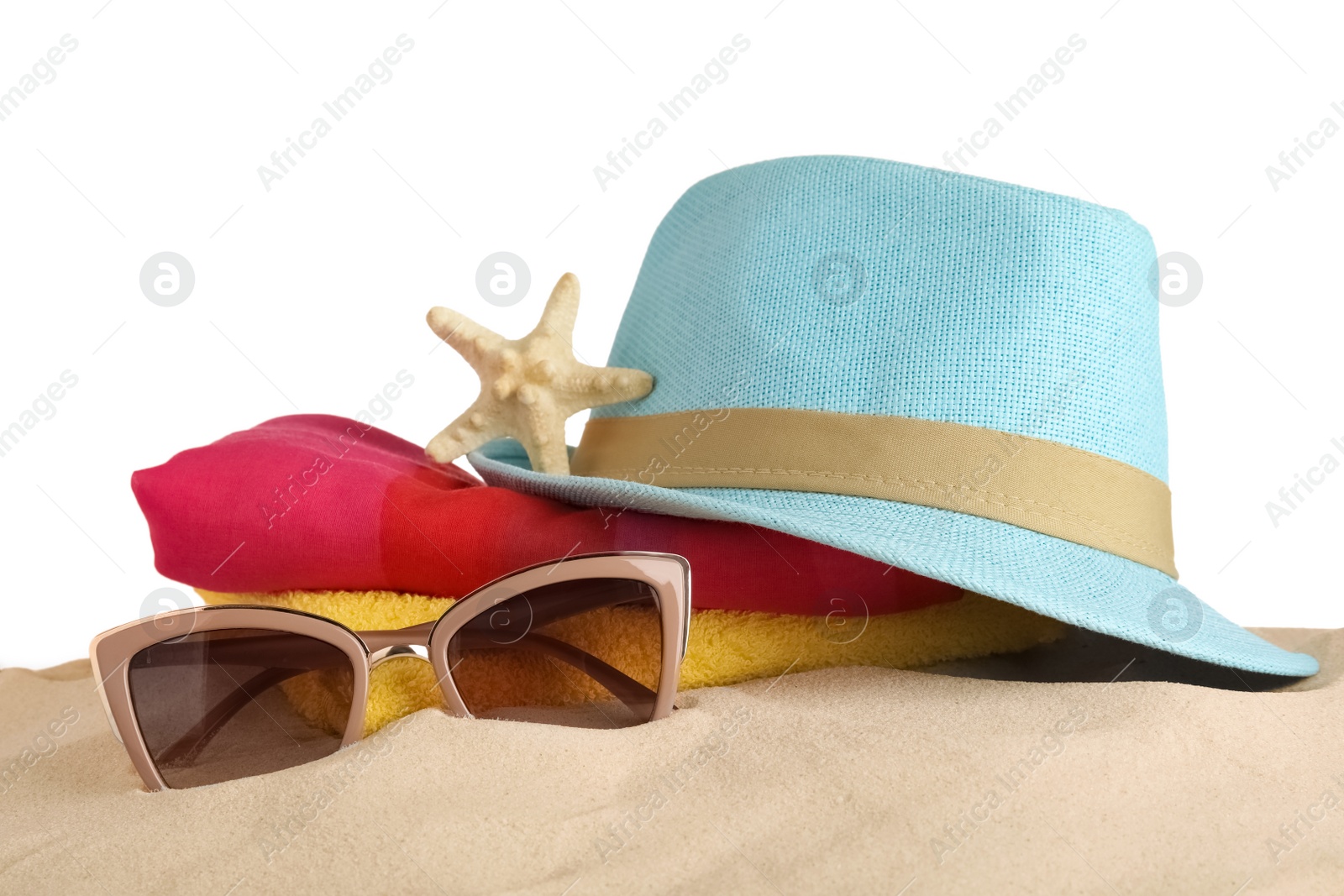 Photo of Beach accessories on sand against white background