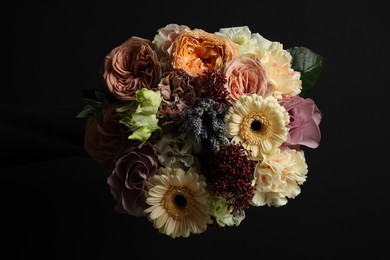 Beautiful bouquet of different flowers on black background