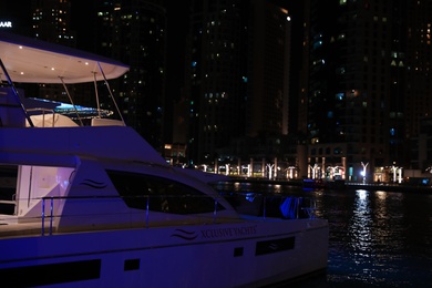 Photo of DUBAI, UNITED ARAB EMIRATES - NOVEMBER 03, 2018: Pier with luxury yacht at night
