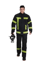Photo of Full length portrait of firefighter in uniform with gas mask on white background