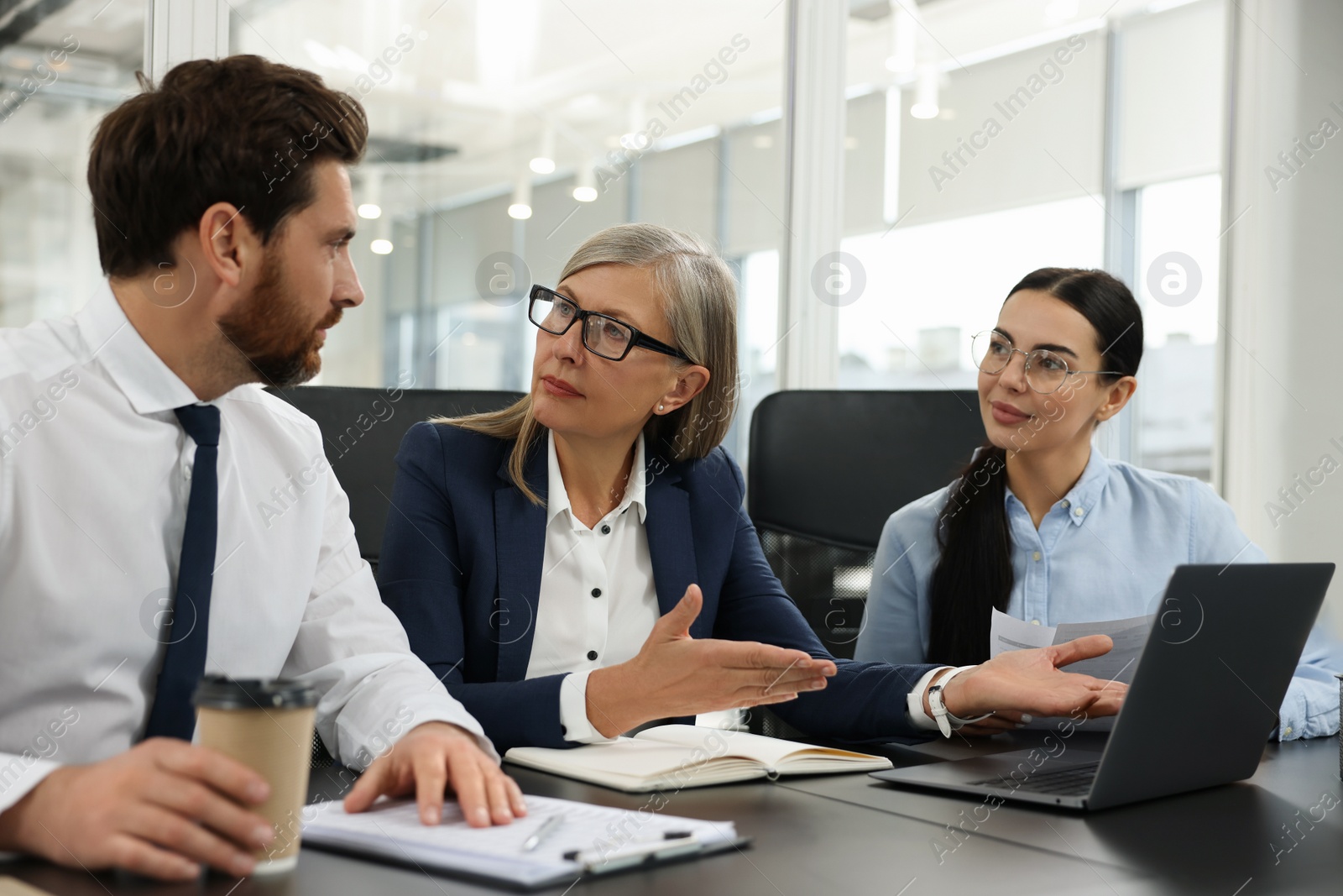 Photo of Lawyers working together at table in office