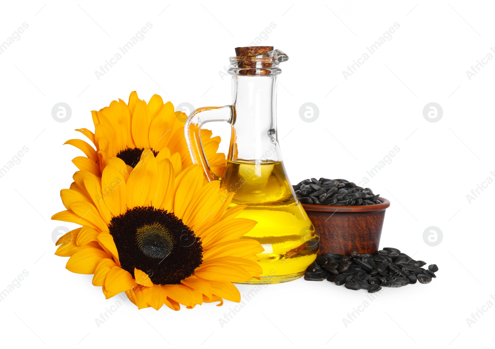 Photo of Sunflower cooking oil, seeds and yellow flowers on white background