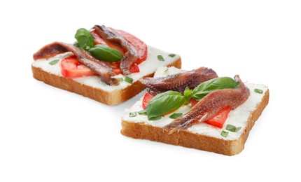 Photo of Delicious sandwiches with cream cheese, anchovies, tomatoes and basil on white background