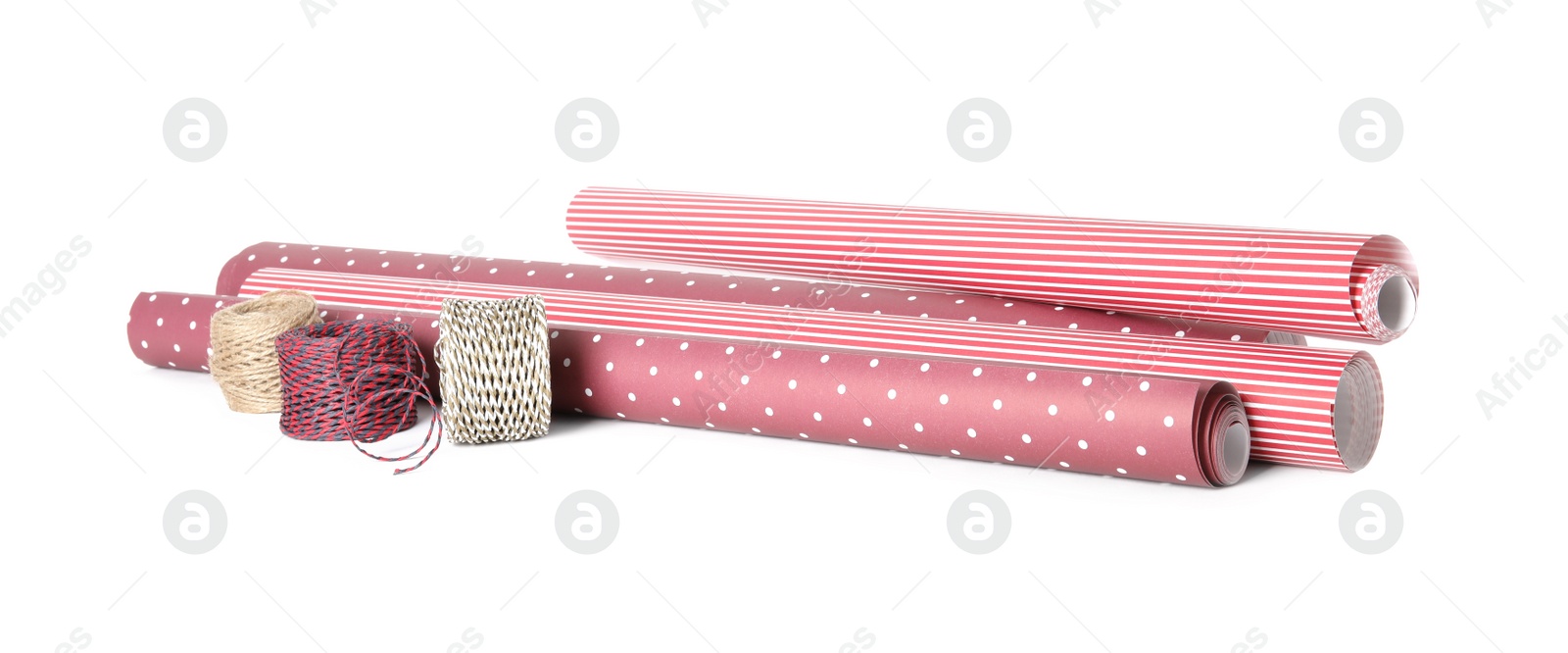 Photo of Different colorful wrapping paper rolls and ropes on white background