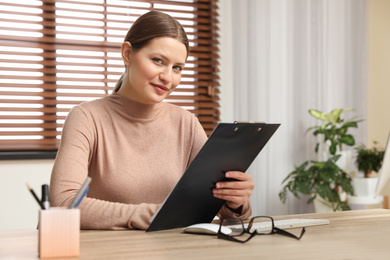 Professional psychotherapist at table in modern office