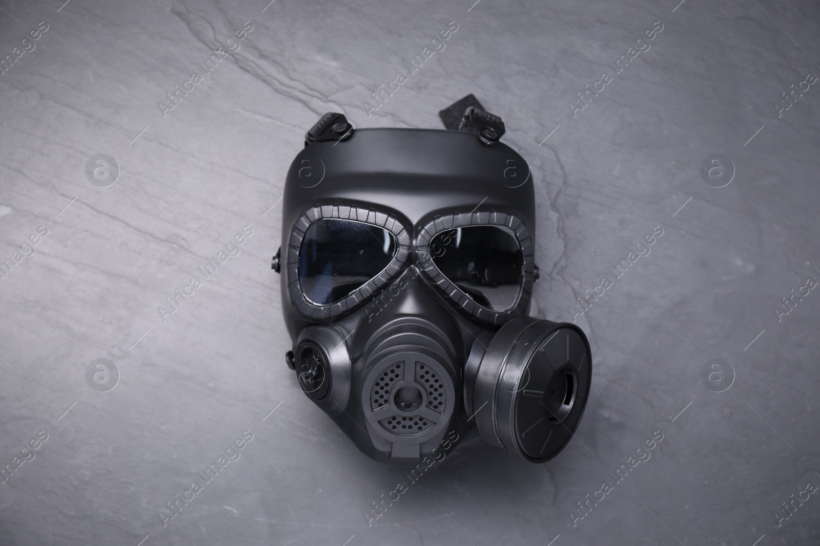 Photo of One gas mask on grey textured background, top view