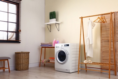 Laundry room interior with modern washing machine