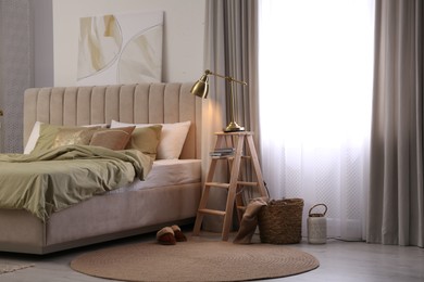 Photo of Comfortable bed with olive green linens in modern room interior