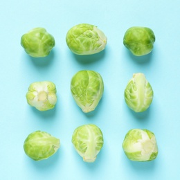 Photo of Fresh Brussels sprouts on color background, flat lay