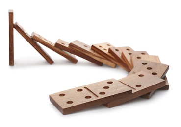 Wooden domino tiles falling on white background