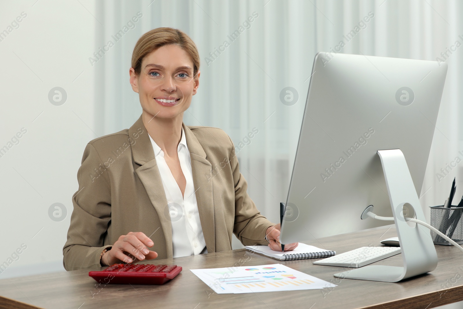 Photo of Professional accountant working at wooden desk in office