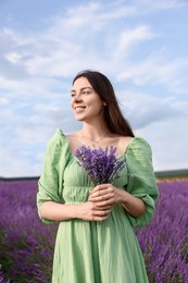 Beautiful woman with bouquet in lavender field