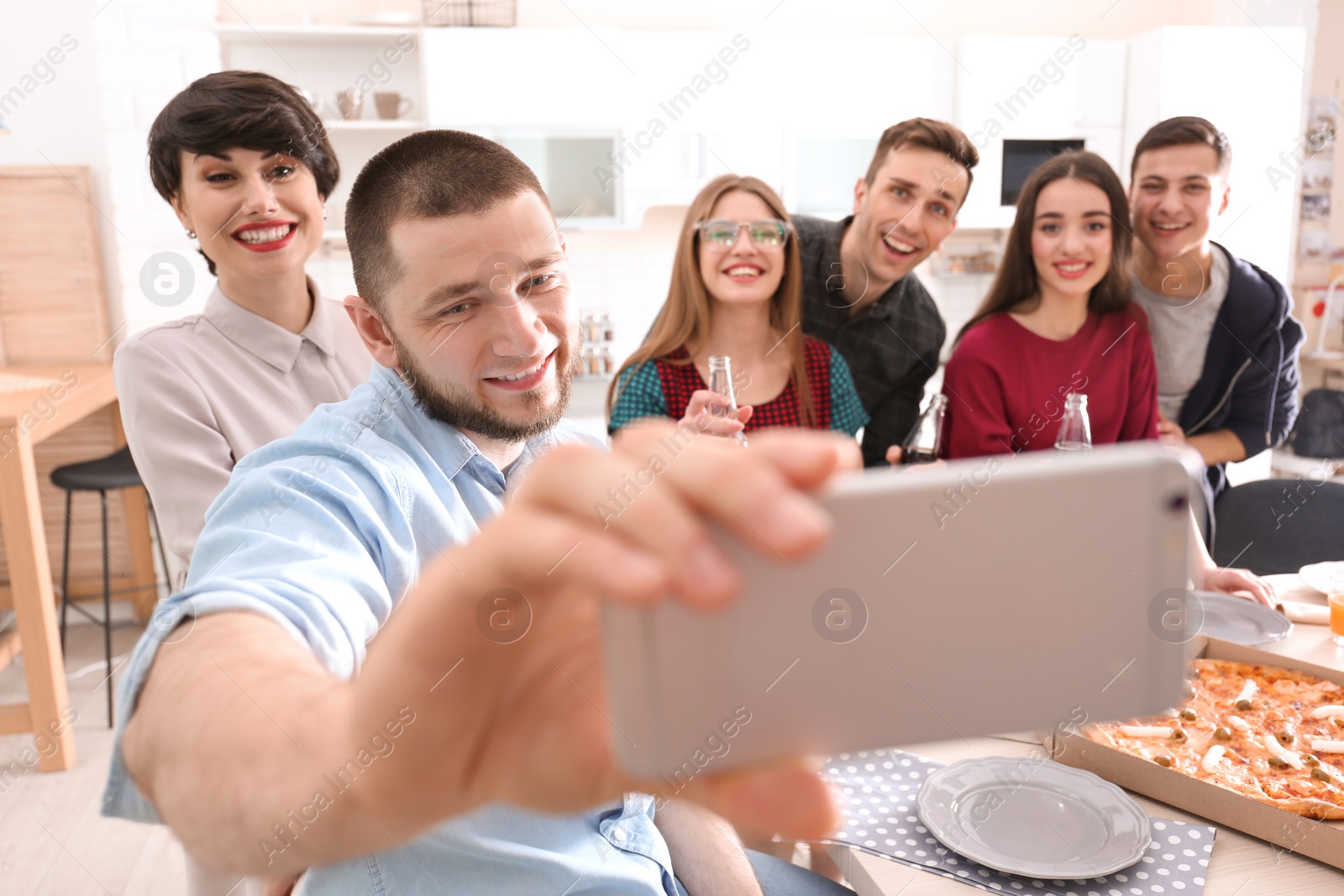 Photo of Happy friends taking selfie indoors