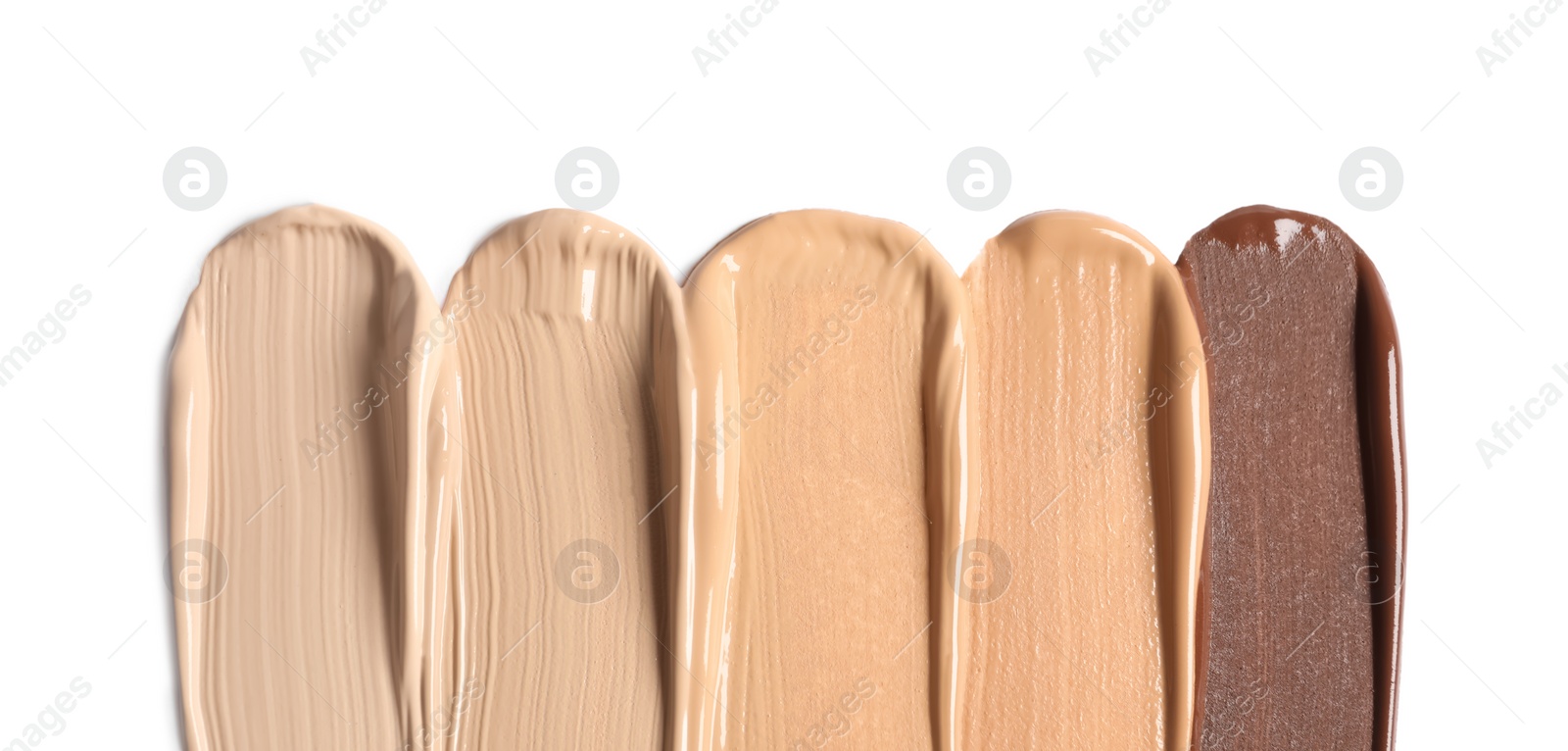 Photo of Samples of skin foundation on white background, top view. Space for text