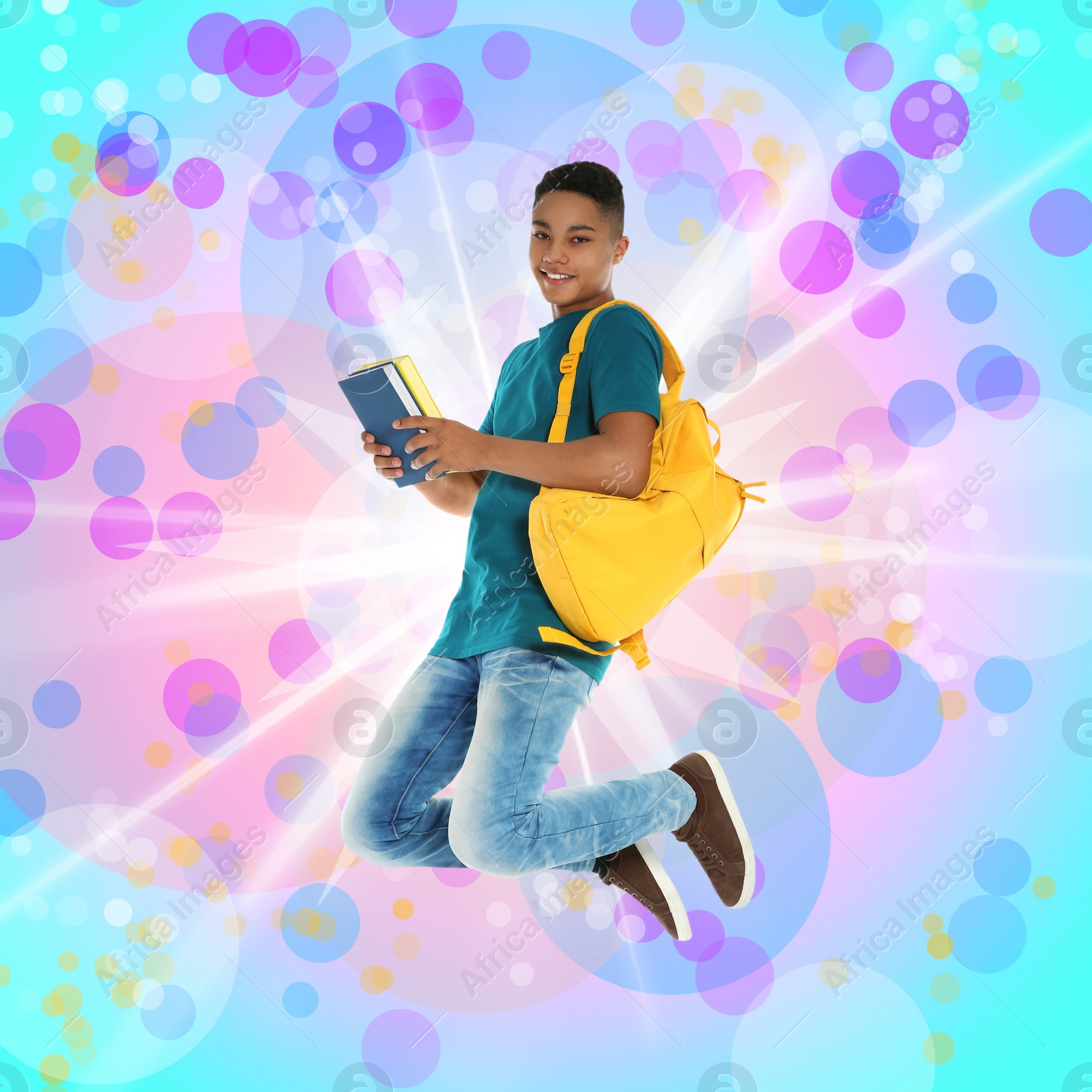 Image of African-American teenager boy jumping on colorful background. School holidays