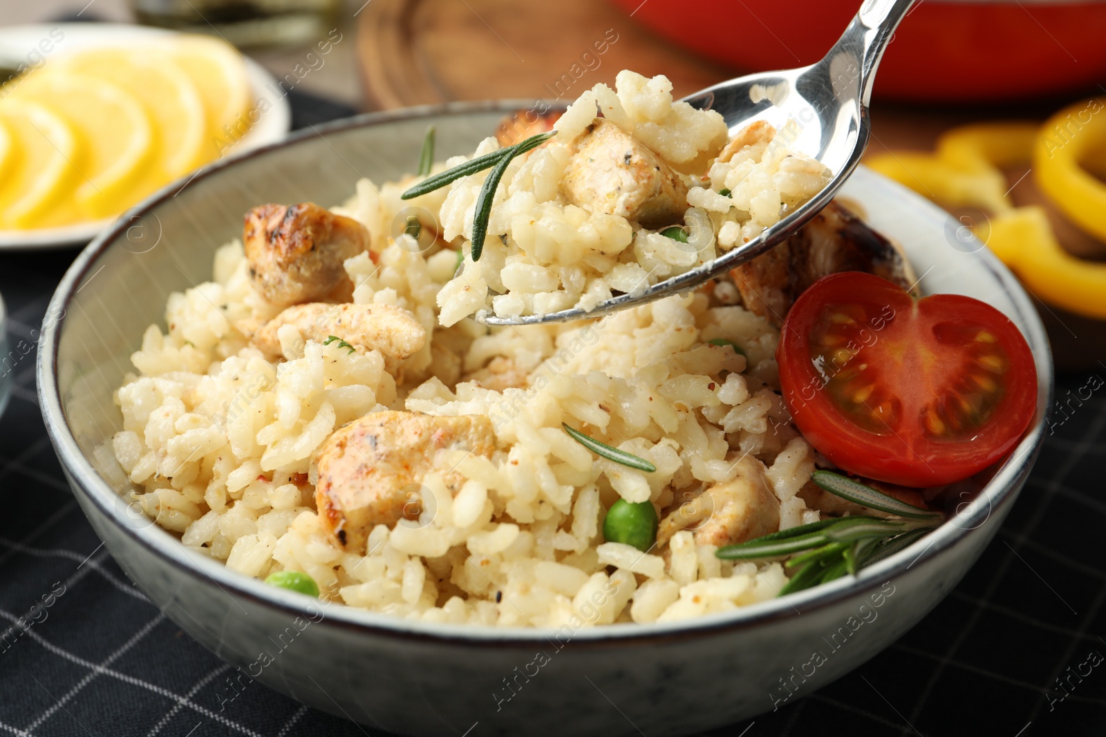 Photo of Delicious chicken risotto with tomato on table, closeup