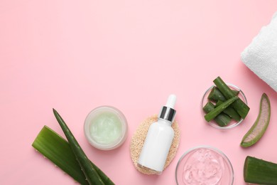 Photo of Flat lay composition with cosmetic products and cut aloe leaves on pink background. Space for text