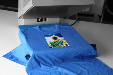 Image of Custom t-shirt. Using heat press to print image of beautiful sunflower