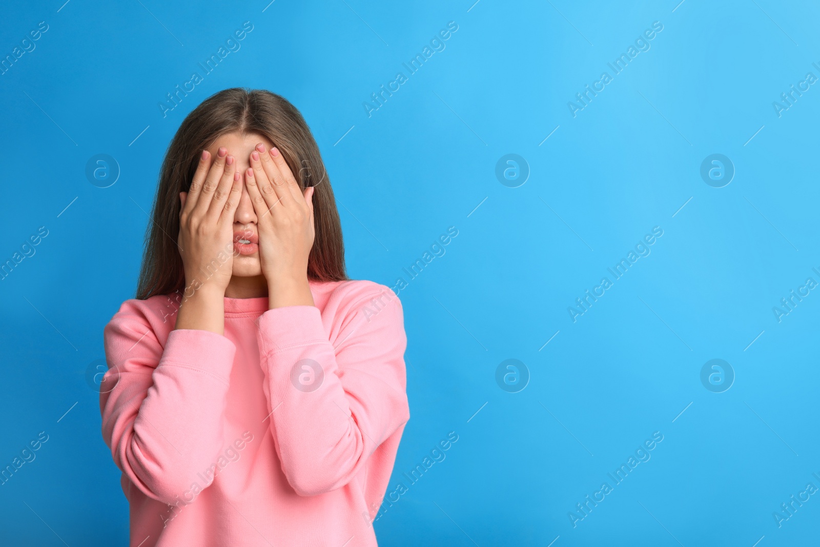 Photo of Young woman being blinded on blue background