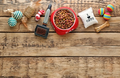Photo of Cat's accessories and food on wooden background
