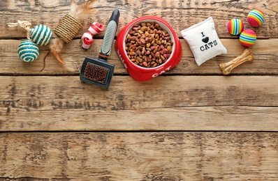 Cat's accessories and food on wooden background