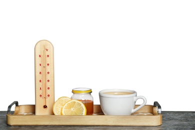 Photo of Thermometer, lemon, honey and cup of tea on table against gray background. Space for text
