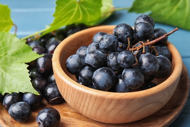 Photo of Fresh ripe juicy grapes in bowl on table, closeup