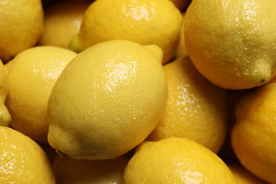 Photo of Fresh lemons with water drops as background, closeup
