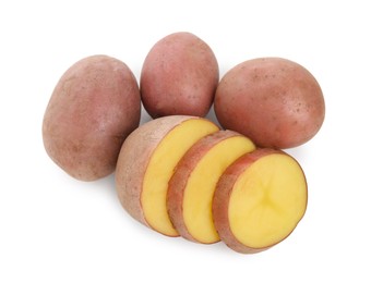 Whole and cut fresh potatoes on white background, top view