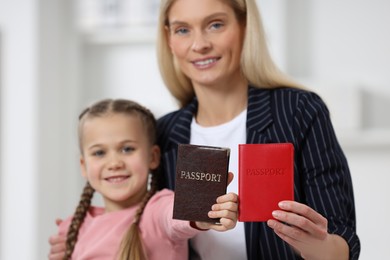 Photo of Immigration. Happy woman and her daughter with indoors, selective focus