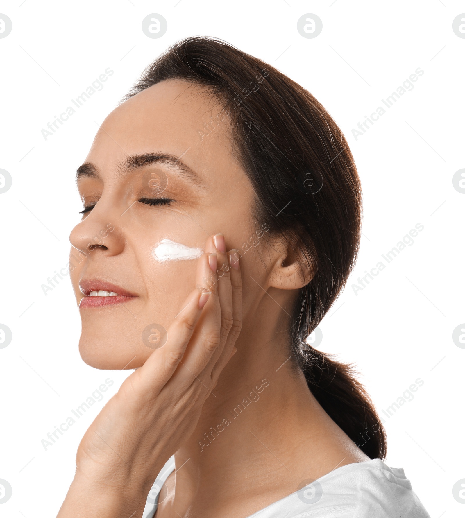 Photo of Woman applying facial cream on white background