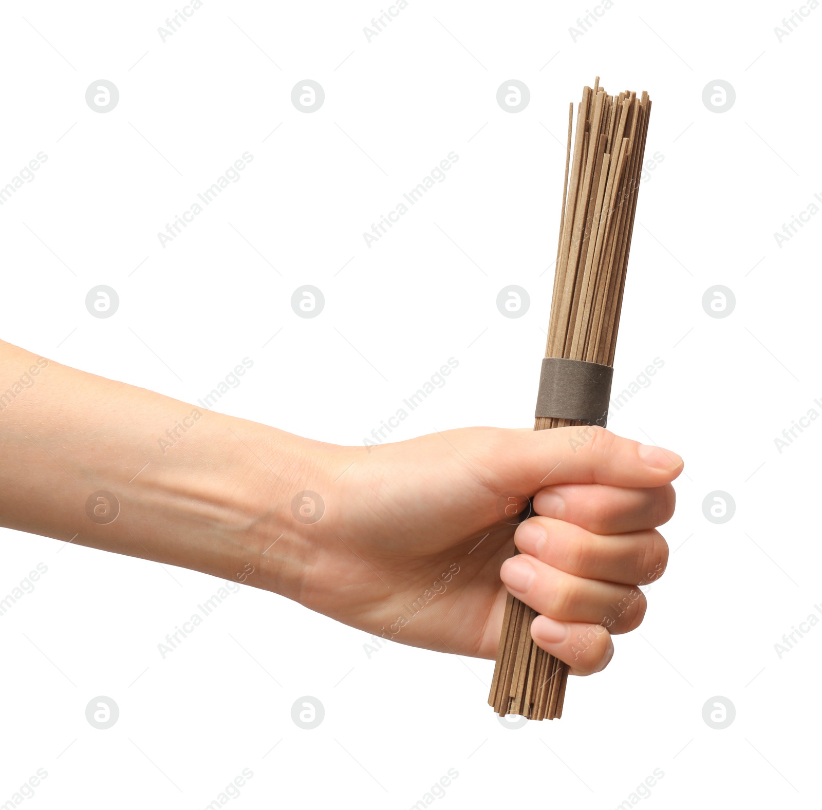 Photo of Woman holding uncooked buckwheat noodles (soba) on white background, closeup. Space for text