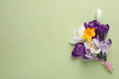 Beautiful crocus bouquet on beige background, top view. Space for text