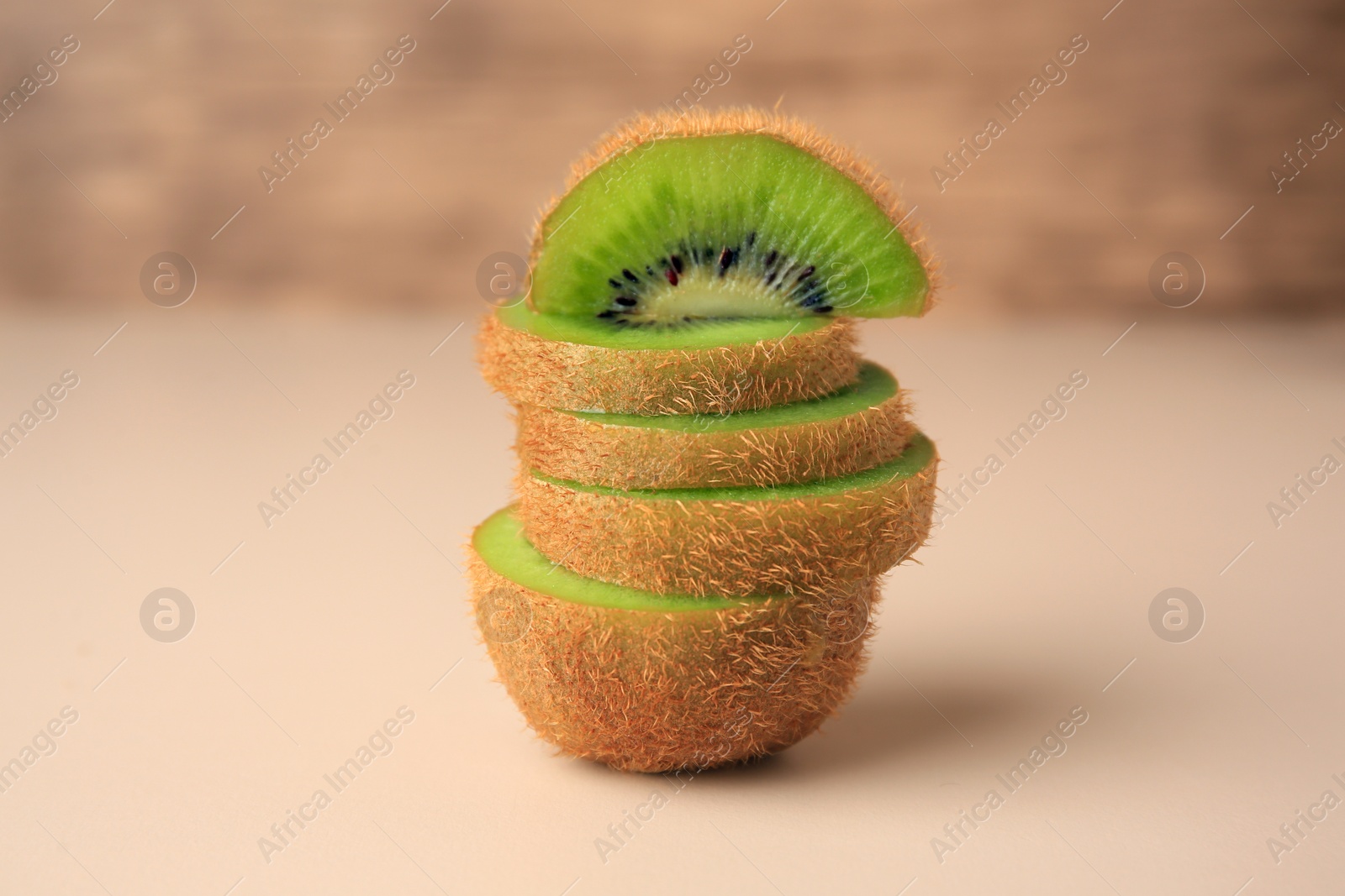 Photo of Sliced fresh ripe kiwi on beige background