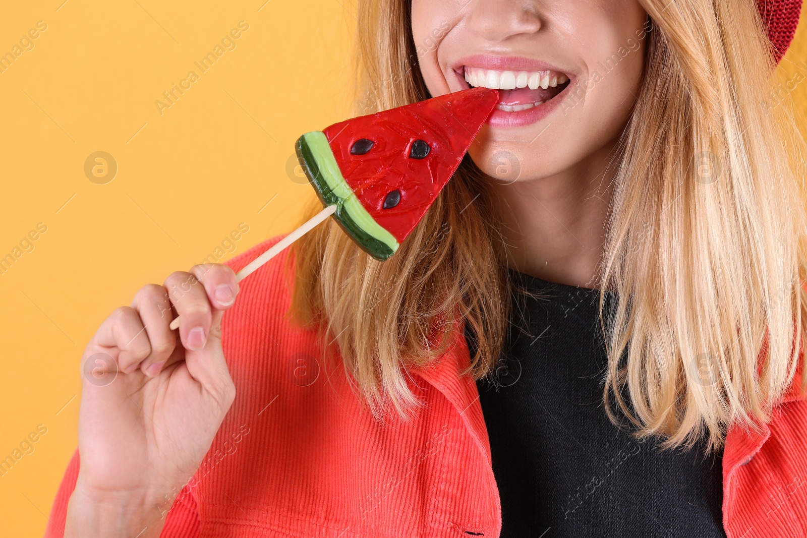 Photo of Young pretty woman with candy on colorful background, closeup