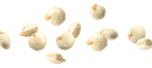 Image of Many quinoa seeds falling on white background, banner design. Vegan diet 