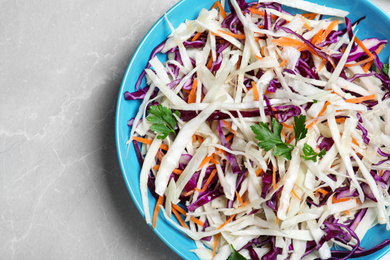 Photo of Tasty salad with cabbage on light grey marble table, top view