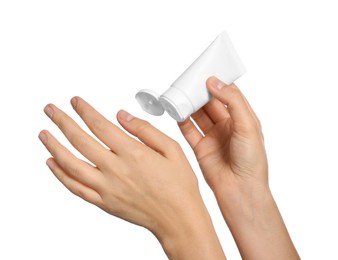 Woman applying cream on her hand against white background, closeup