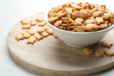 Photo of Delicious goldfish crackers in bowl on table