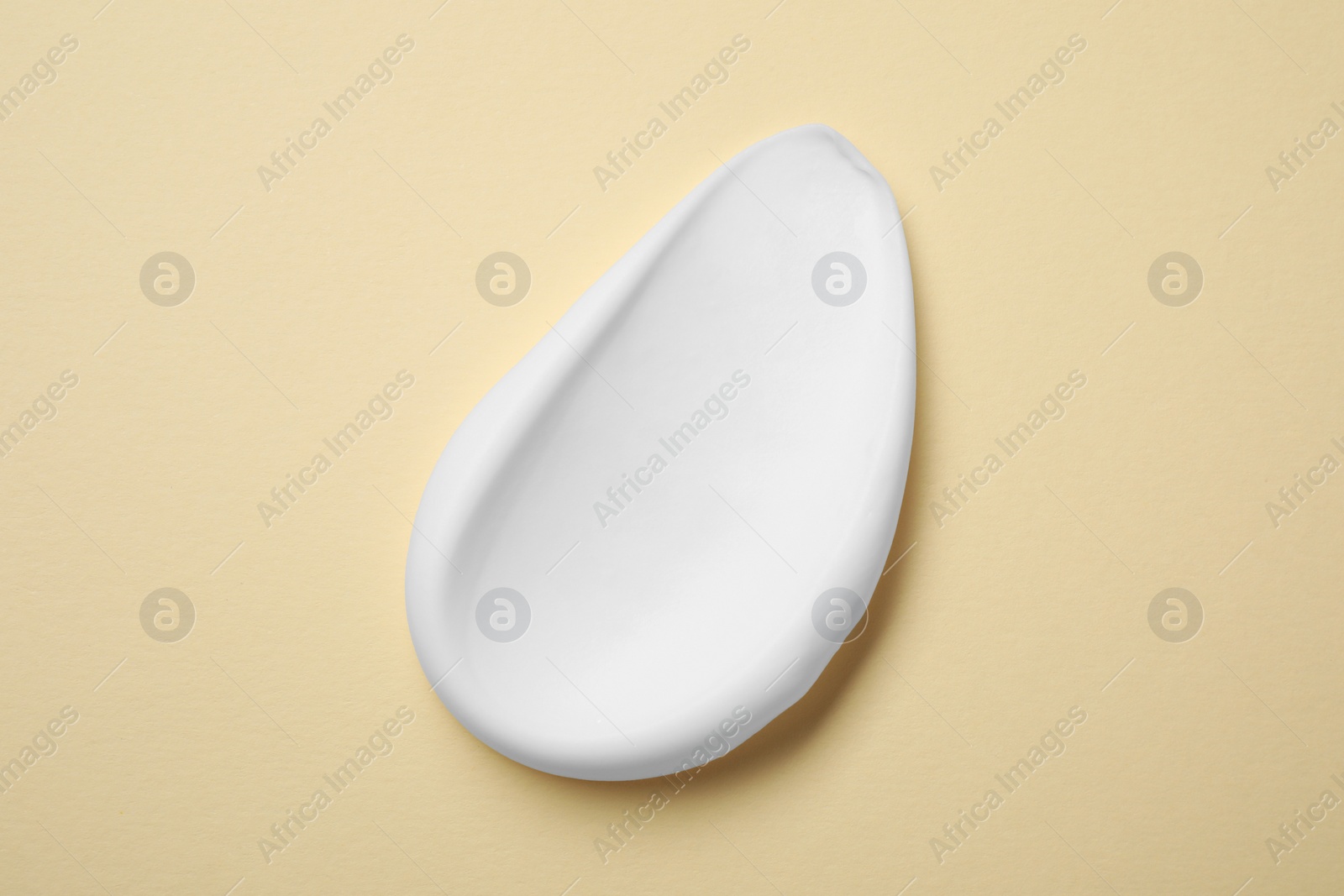 Photo of Sample of shaving foam on beige background, top view