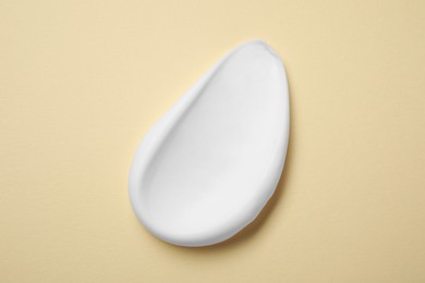 Sample of shaving foam on beige background, top view