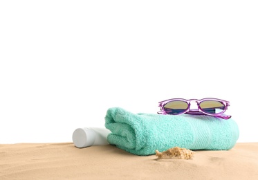 Photo of Composition with beach sand, sunglasses and towel on white background, space for text