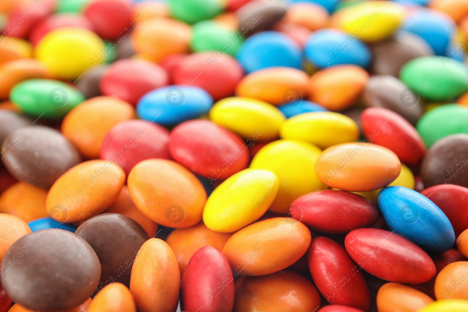 Photo of Many small colorful candies as background, closeup