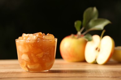 Delicious apple jam and fresh fruits on wooden table