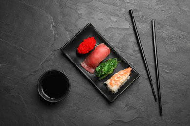 Set of delicious sushi on grey table, flat lay