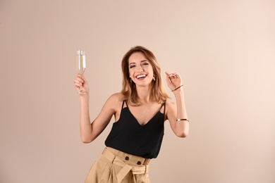 Photo of Portrait of happy woman with champagne in glass on color background