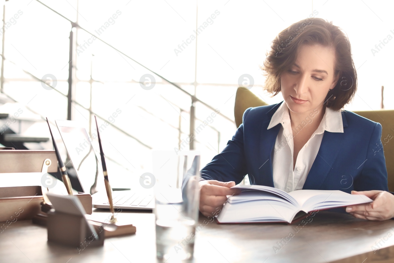 Photo of Female lawyer working at table in office