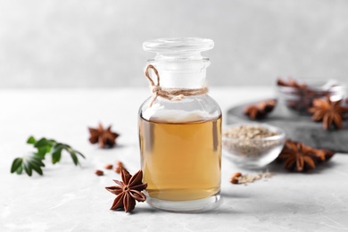 Photo of Anise essential oil and spice on light table