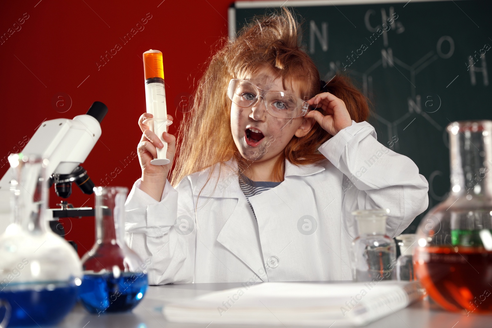 Photo of Child doing chemical research in laboratory. Dangerous experiment