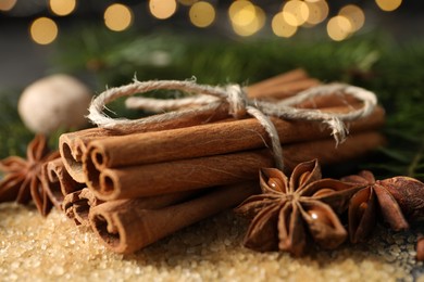 Photo of Different spices on table against blurred lights, closeup